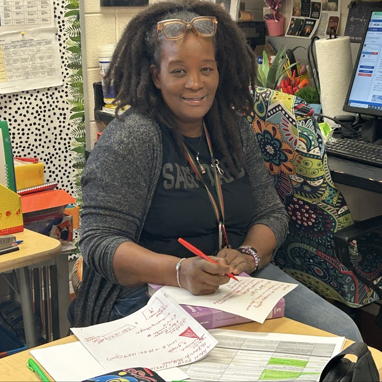 Teacher sitting looking at data and developing lessons for her students  