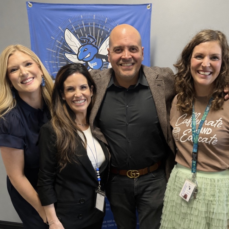 for professional educators forward facing posed in front of the B branch school district sign
