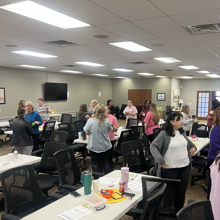 Educators move around the room connecting with colleagues during a professional development session.