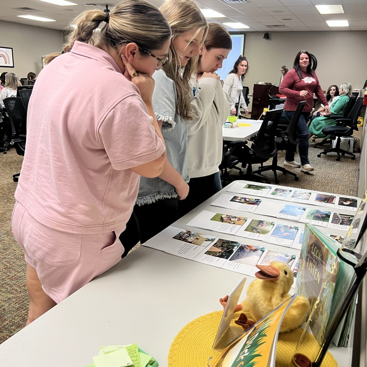 Providers examine classroom materials and activity cards related to outdoor learning.