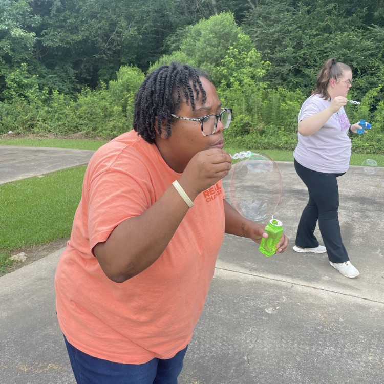 teacher blowing bubbles 