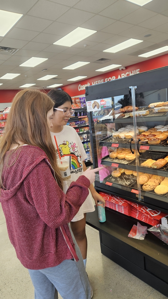 Girls choosing from the selection of donuts 