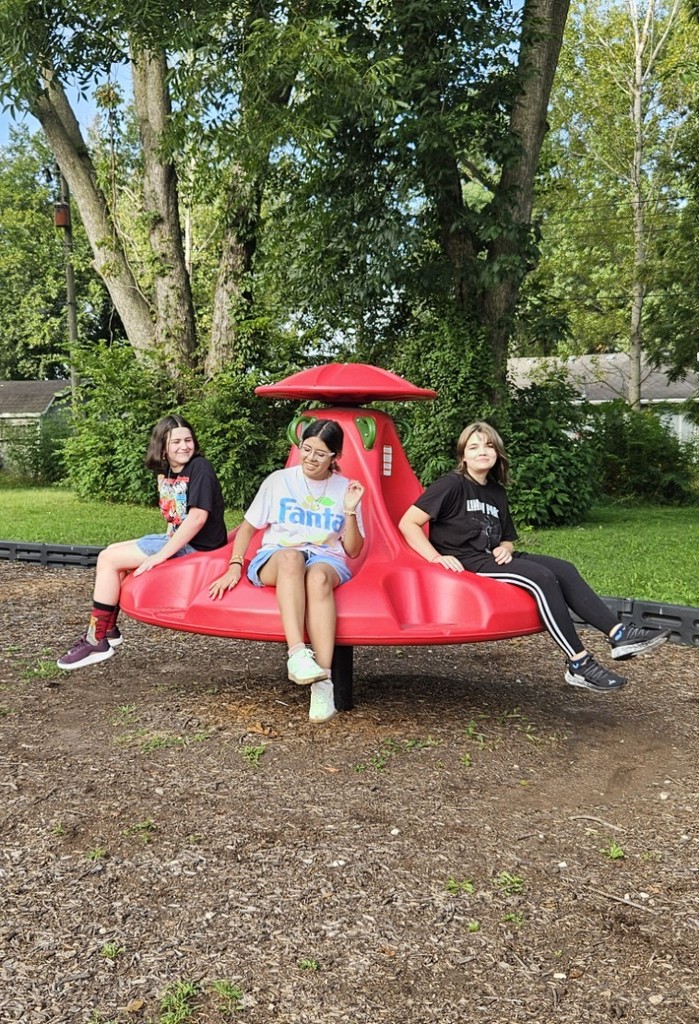 students playing on the spinning mary-go-round