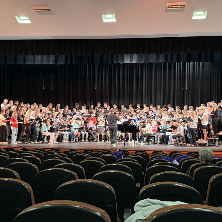 158 singers in rehearsal on stage