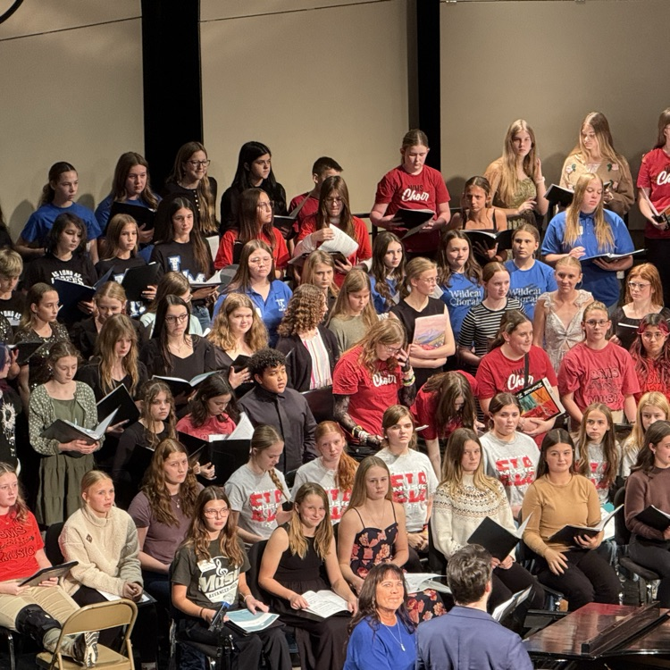 7/8th grade honor choir rehearsing on stage