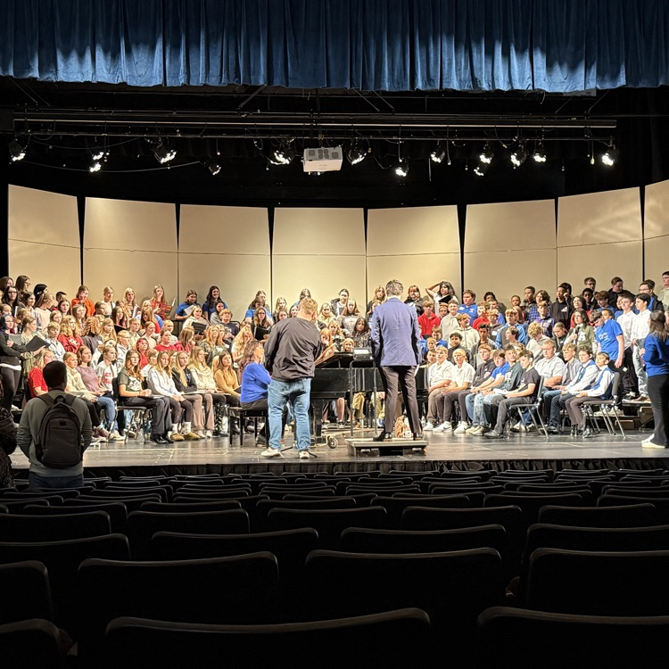 7/8th grade honor choir rehearsing on stage