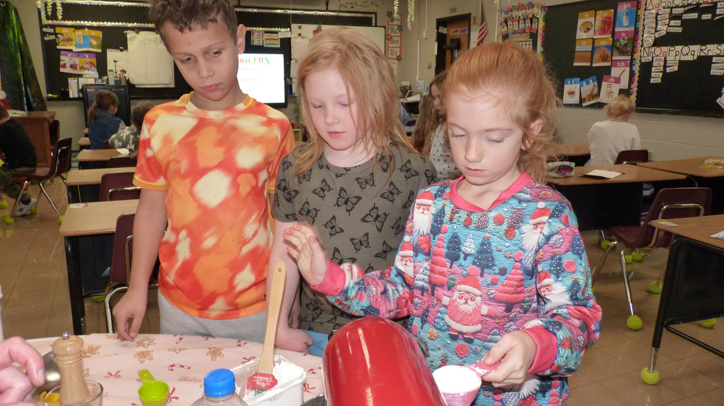 2nd graders mix up cookie dough.