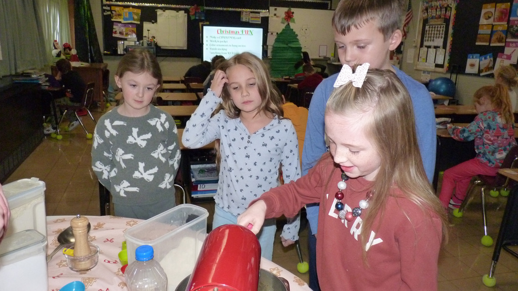 2nd graders mix up cookie dough.