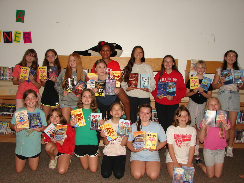 Students pose with books for the reader's award challenge