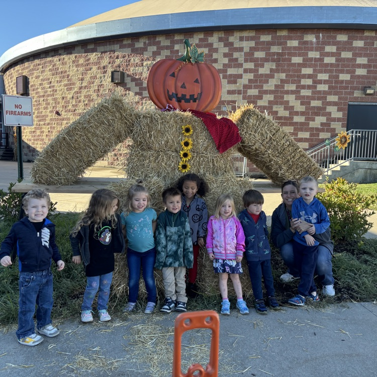 posing w pumpkin hay bales 