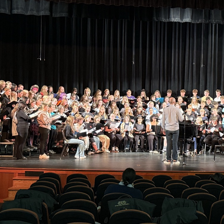 Dr. Jordan Cox speaking to choir members during rehearsal