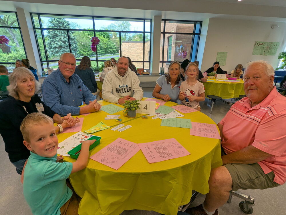 Kindergarden student with adults at the cafe