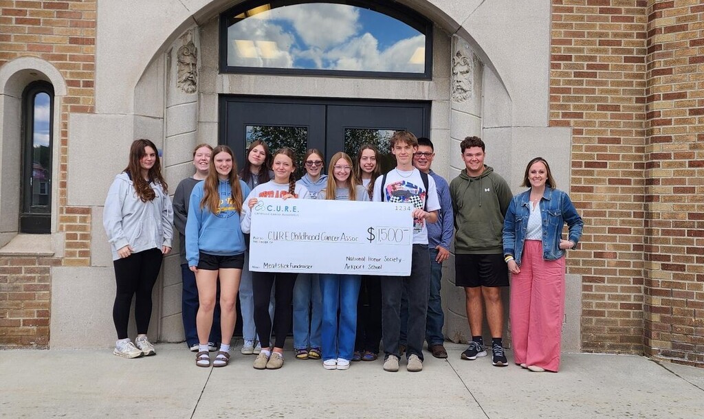 NHS students with a check