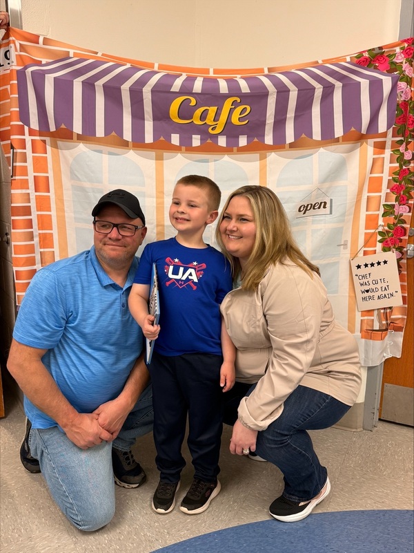 Kindergarden student with adults at the cafe