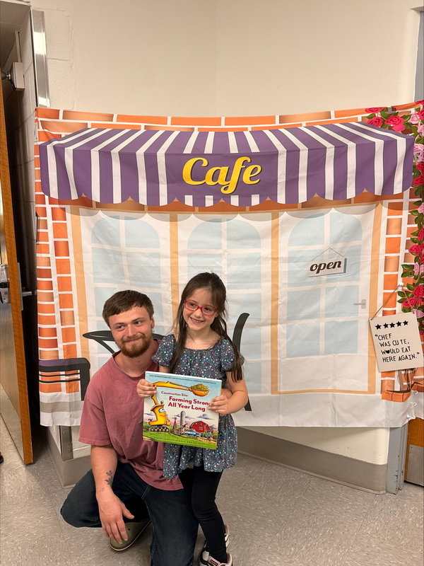 Kindergarden student with adults at the cafe
