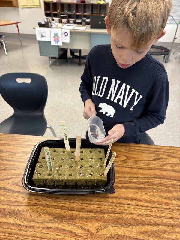 student planting seeds