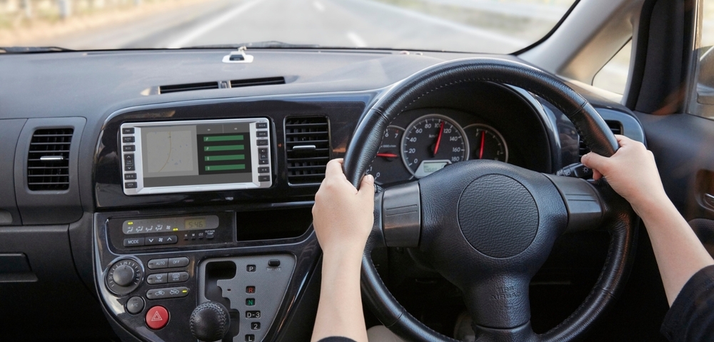 image of inside of vehicle with driver at the wheel