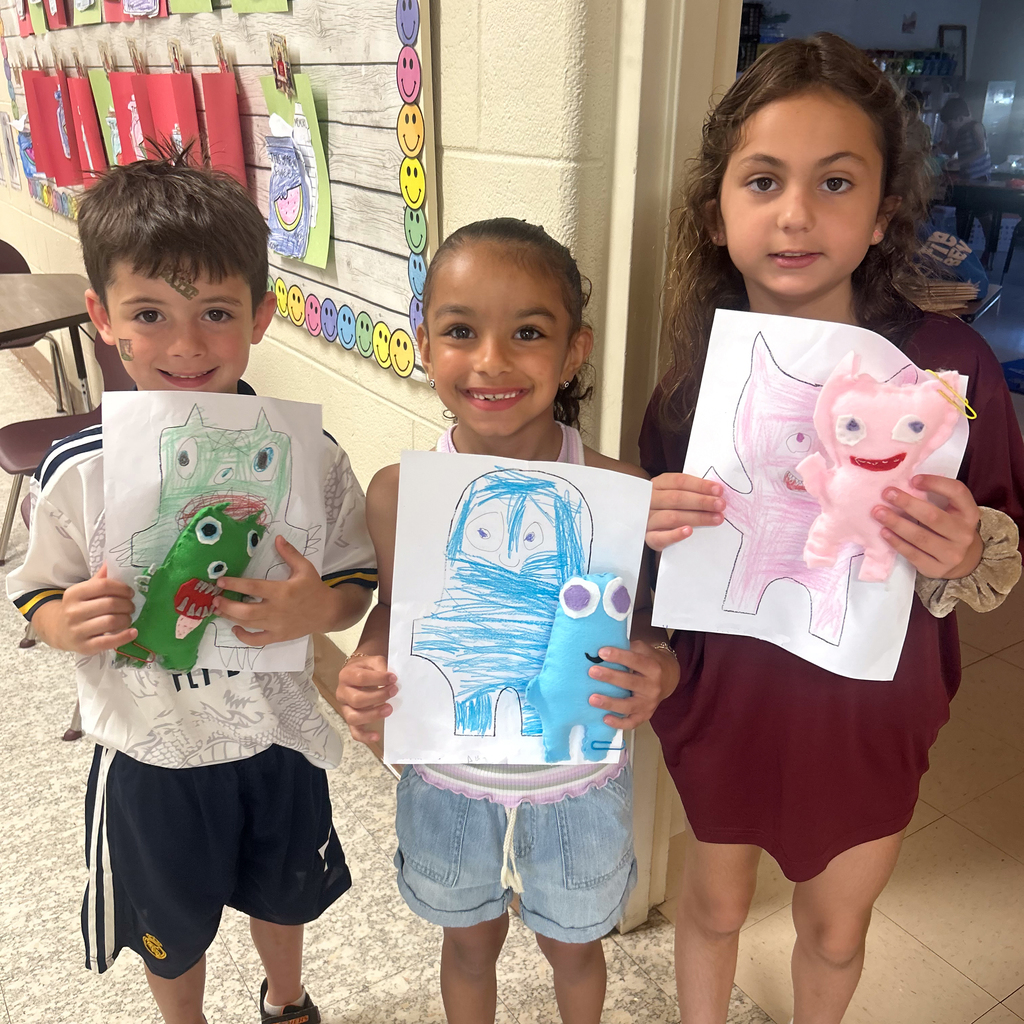 3 Vail students with their monsters and their original drawing
