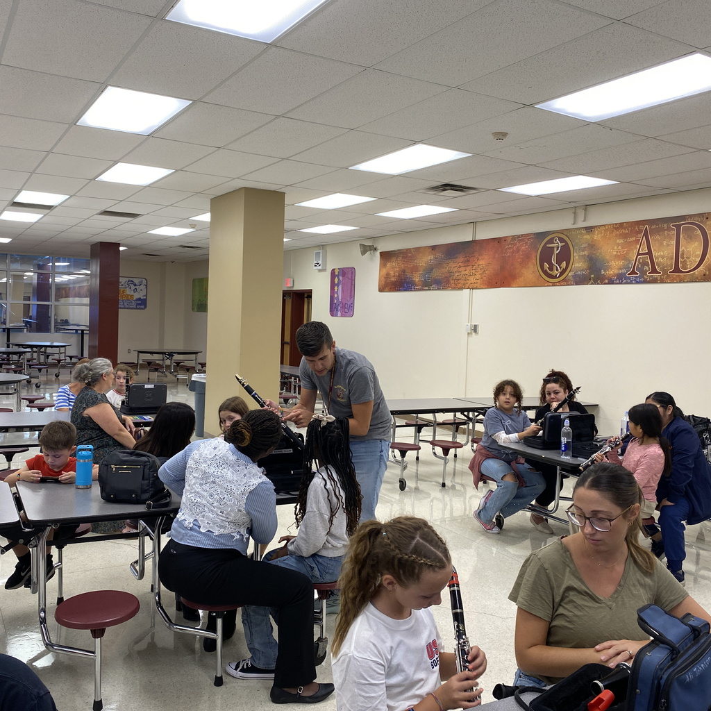 Band teacher assisting student with clarinet