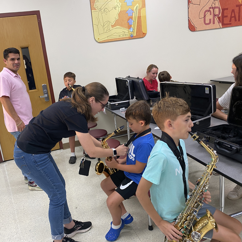 Student getting assistance with saxophone