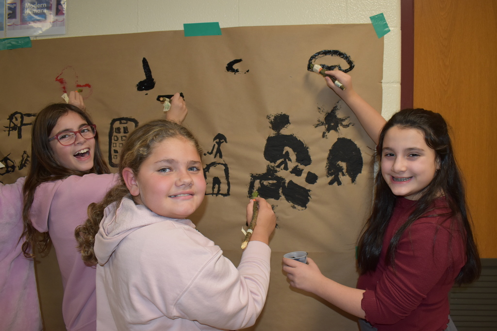 6th graders creating a "cave painting" 