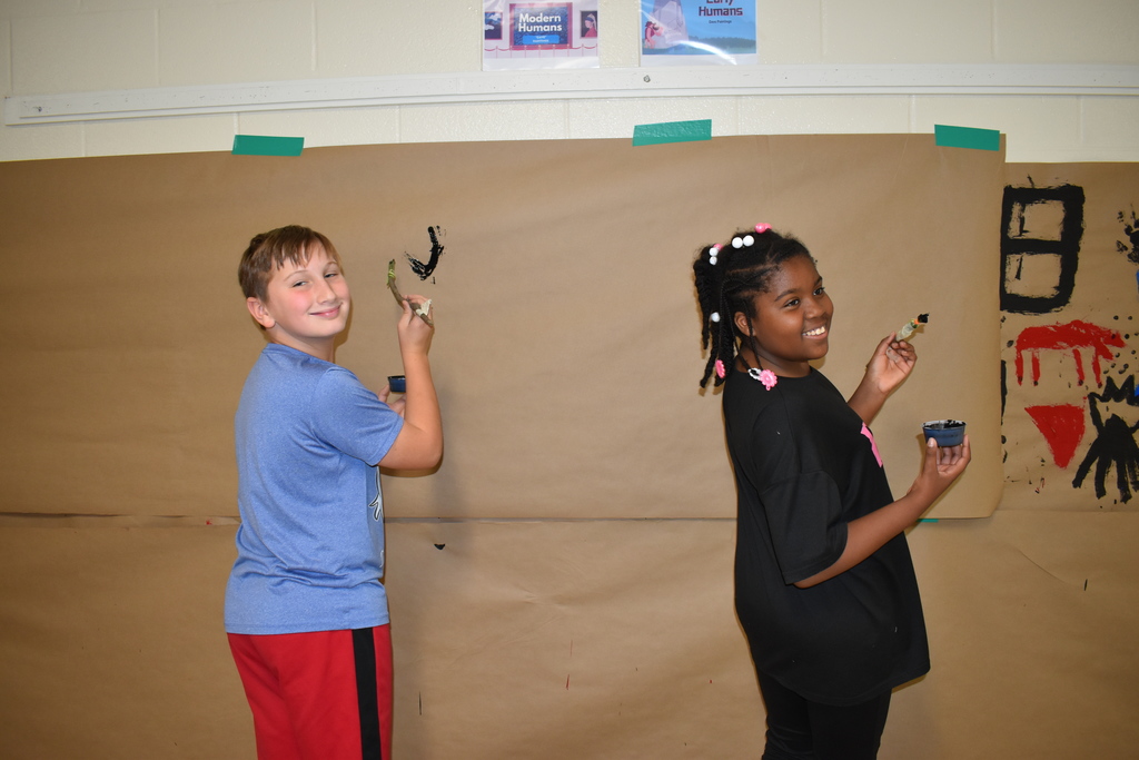 6th graders creating a "cave painting" 