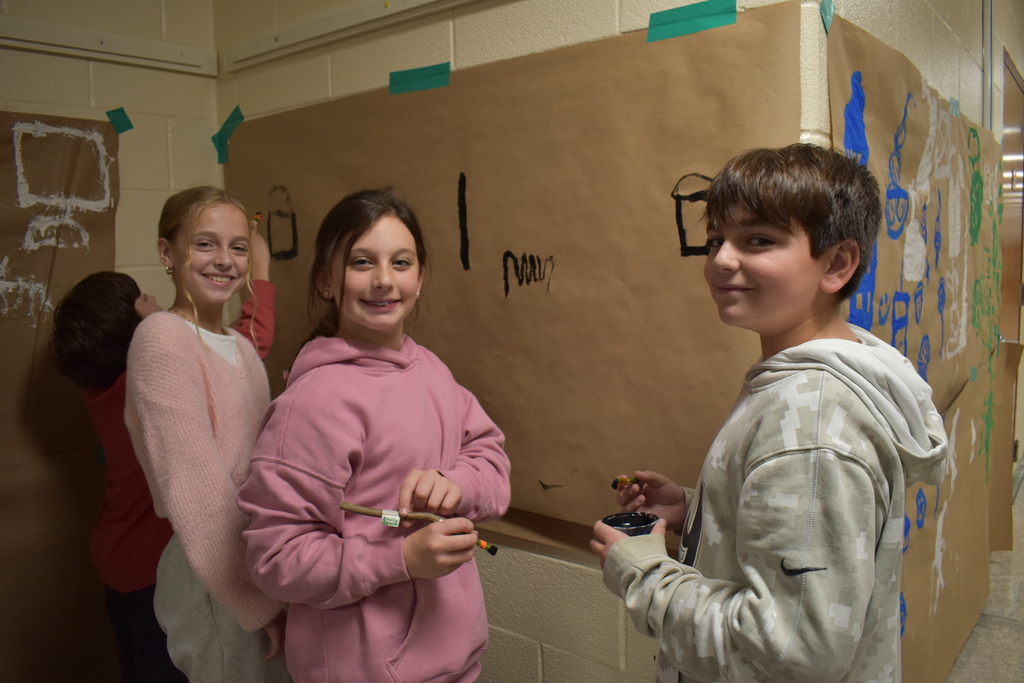 6th graders creating a "cave painting" 
