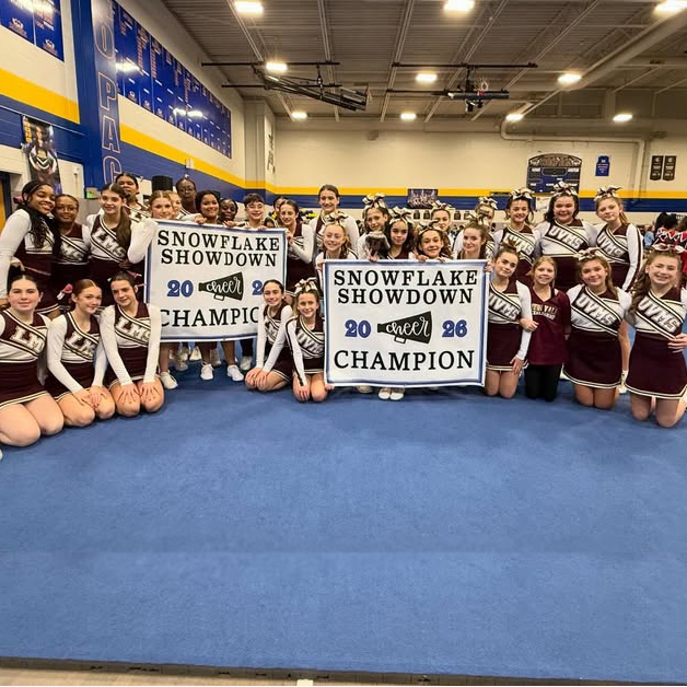 Union Vale and LaGrange MS modified cheerleading teams each holding a sign that reads: Snowflake Showdown 2026 Champion