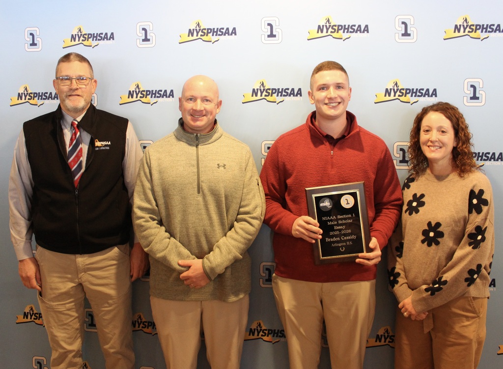 Braden Cassidy with his family and Arlington Athletic Director Mike Cring