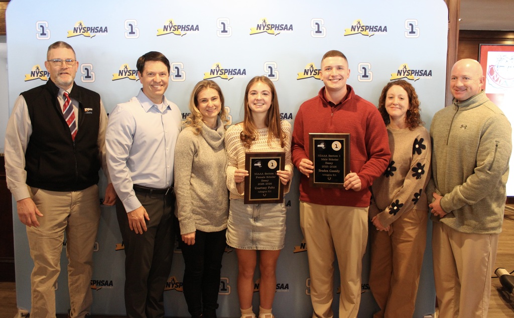 Courtney Foltz and Braden Cassidy with their families and Arlington Athletic Director Michael Cring (at left)