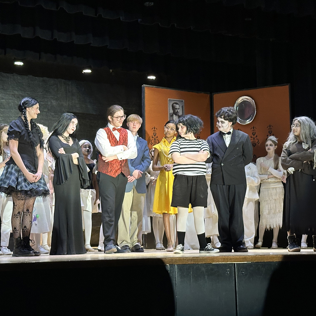 Scene from the LMS performance of The Addams Family Musical, with Wednesday, Morticia,  Gomez, Pugsley, Lurch in center