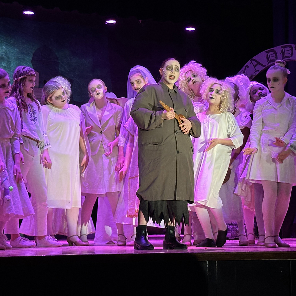 Scene from the LMS performance of The Addams Family Musical, with Uncle Fester center stage