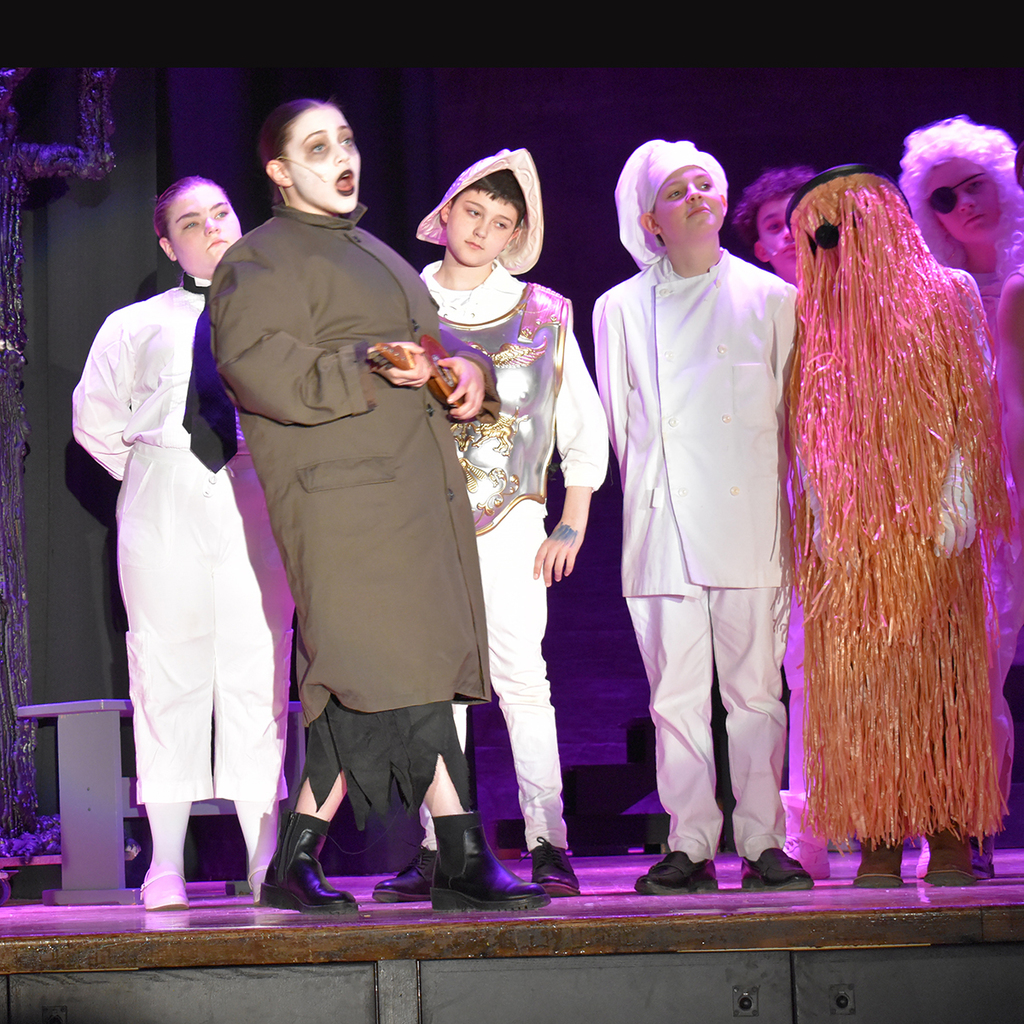Scene from the LMS performance of The Addams Family Musical, with Uncle Fester and Cousin It