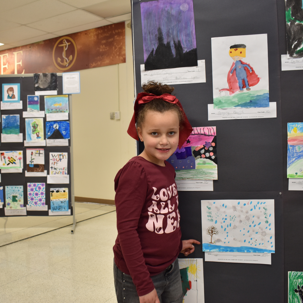 Student next to their artwork