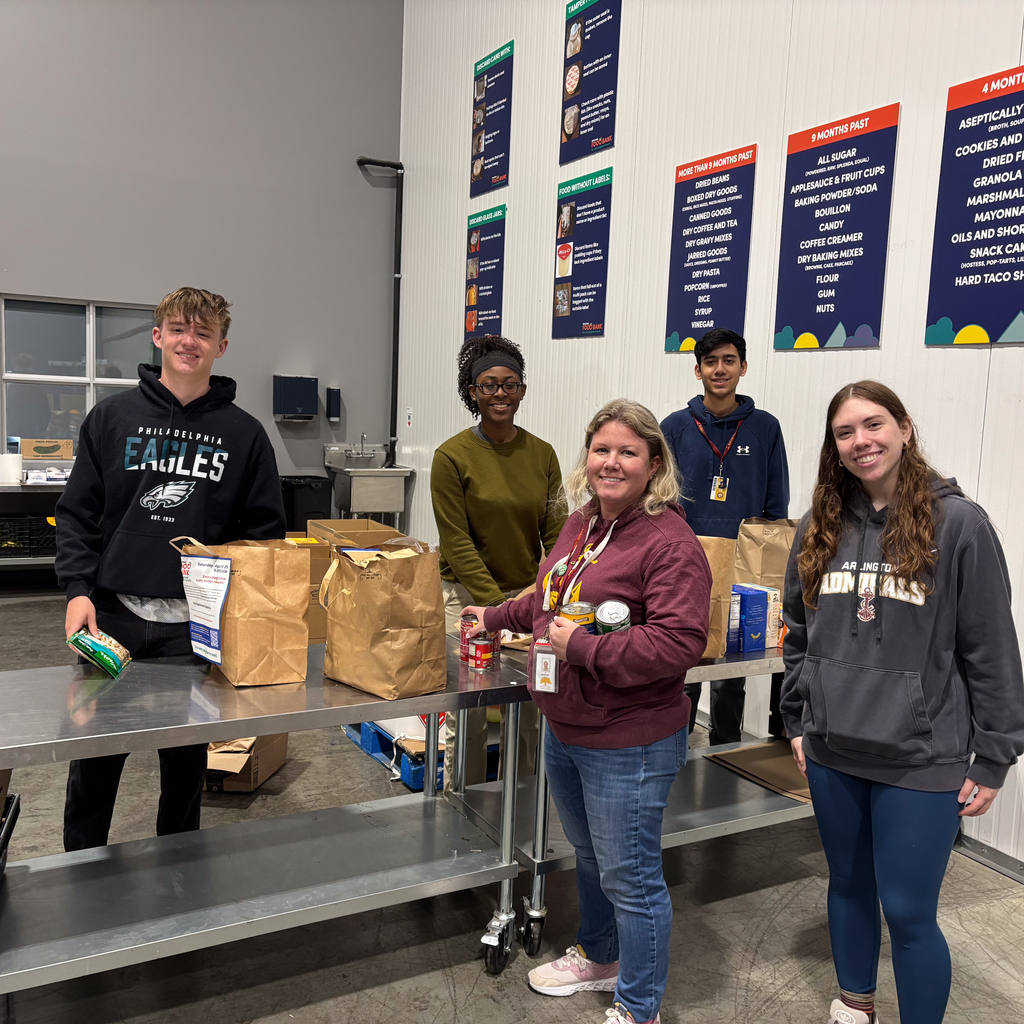 4 Arlington HS students with teacher sorting food at the food bank.