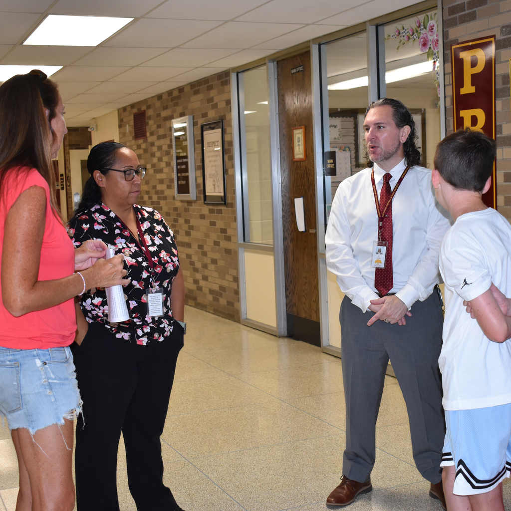 Lissette Torres-Morales, and Matthew Juda chat with  a parent and incoming student.