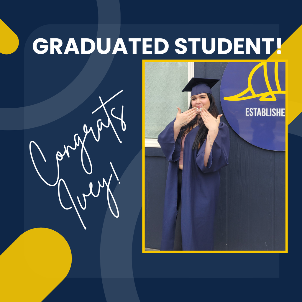 picture of graduate ivey in front of school building