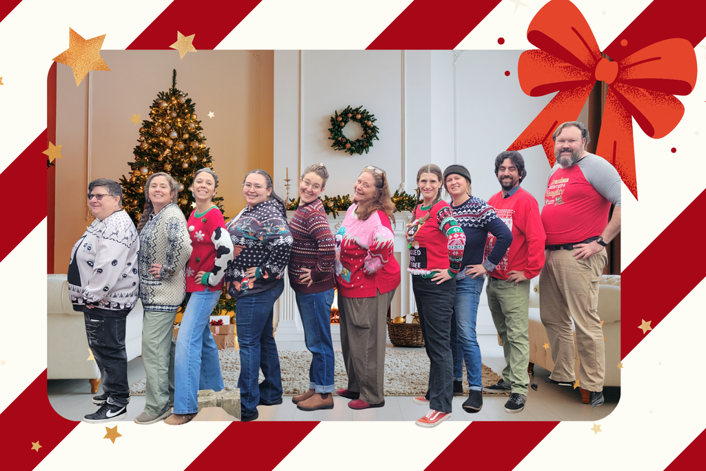 armadillo staff standing in a row in christmas sweaters