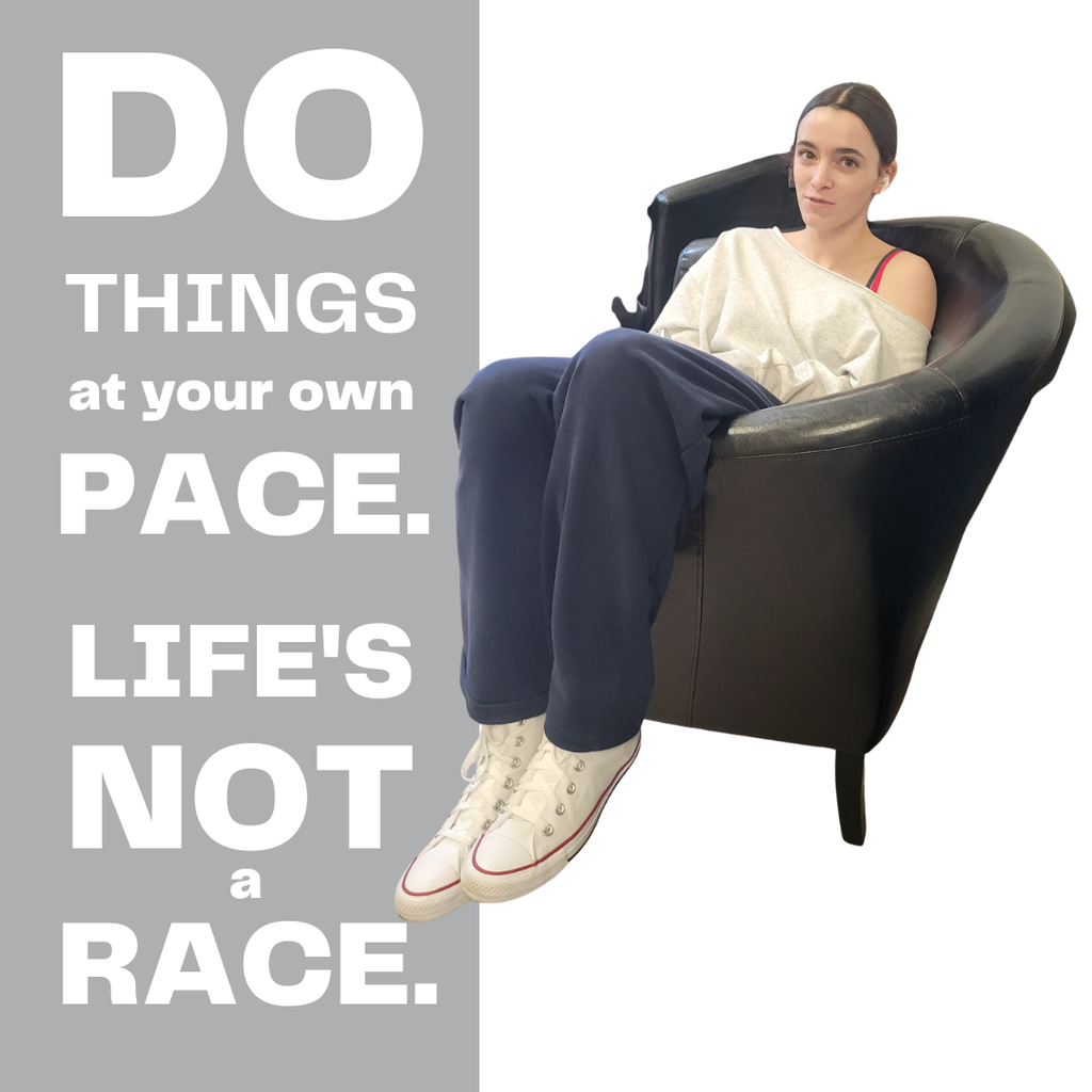 girl sitting in arm chair on white background with do things at your own pace. life's not a race written on the left side