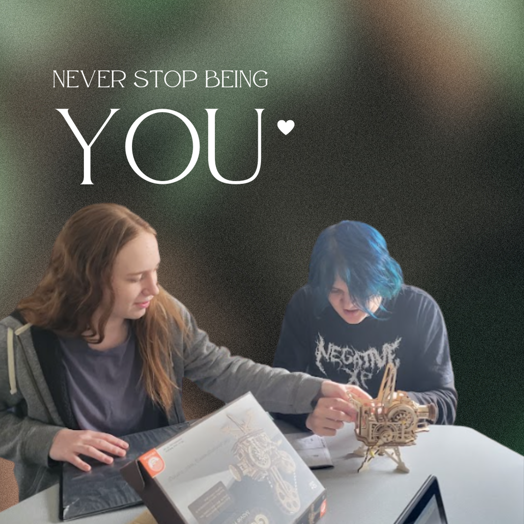 Two students building a movie projector from wood