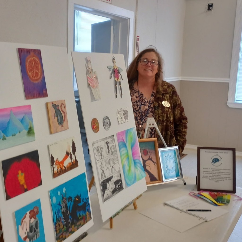 Jodie standing by student artwork