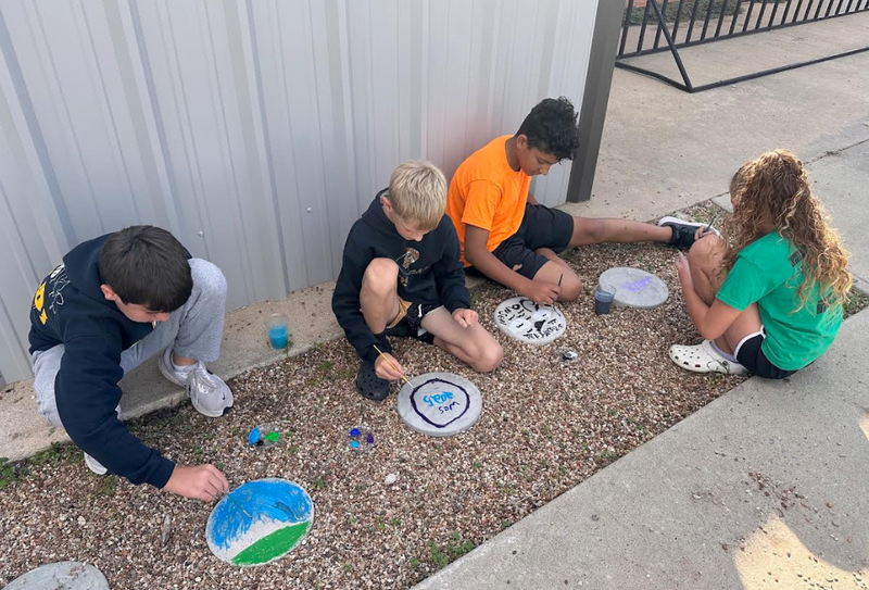 Kale Dunham, Wesley Wheeler, Jansen Hamilton, and Kyler Johnson paint their stepping stones for science class. 