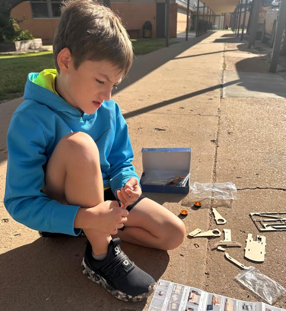 Beau Bryant focuses on building his car.