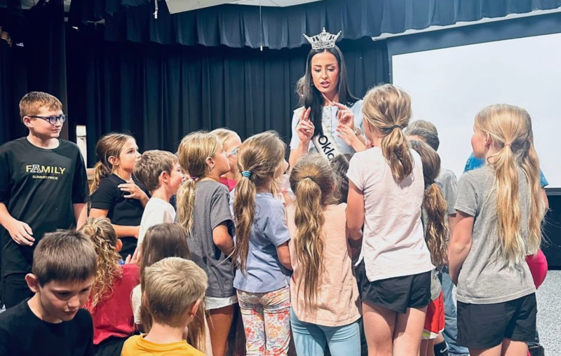 Miss Oklahoma interacting with students.