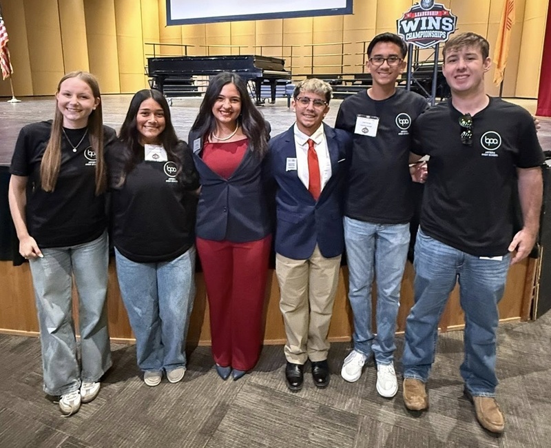 Three female and three male teens pose for the camera.