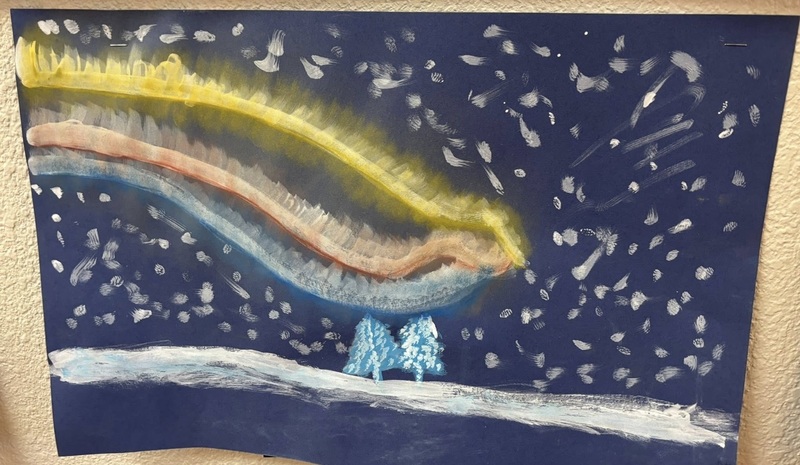 A child's drawing features yellow, pink and blue lines representing the northern lights against a dark-blue snowy background.