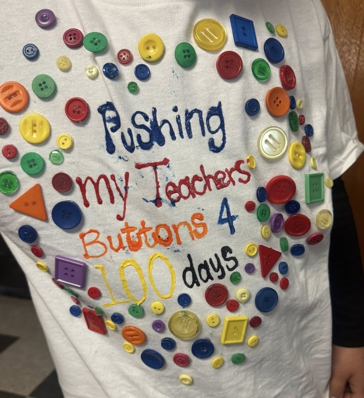 A shirt covered in colorful plastic buttons is shown. It reads "Pushing my teacher's buttons 4 100 days."