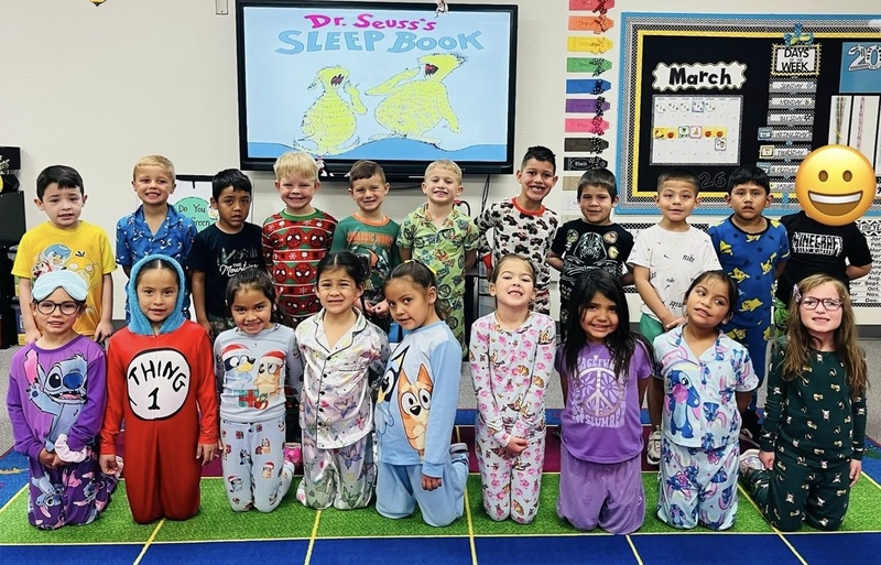 A group of children in pajamas poses for a photo.