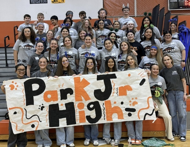 A group of teens hold a banner reading "Park Junior High."