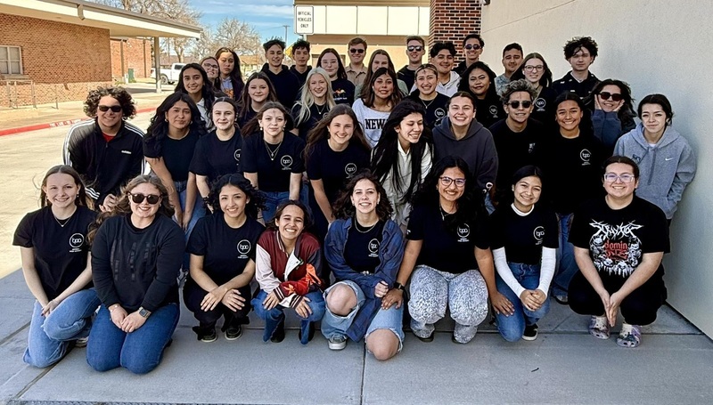 A large group of teens pose for a photo.